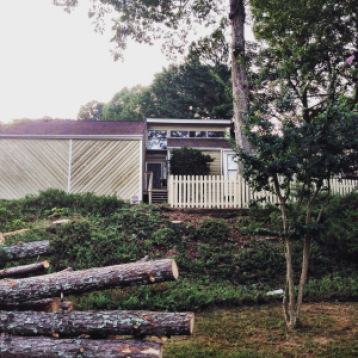 After we had 13! pine trees taken out of the front yard. Who knew there was even a house back there? 